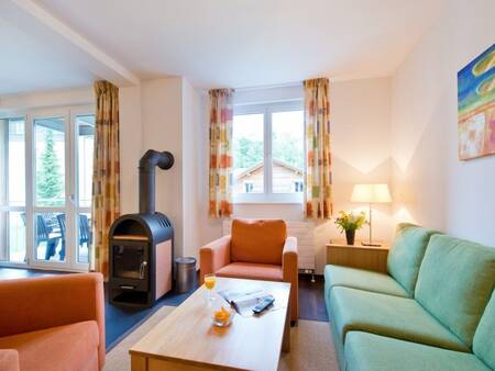 Living room with a wood stove of an apartment at Landal Alpen Resort Vierwaldstättersee