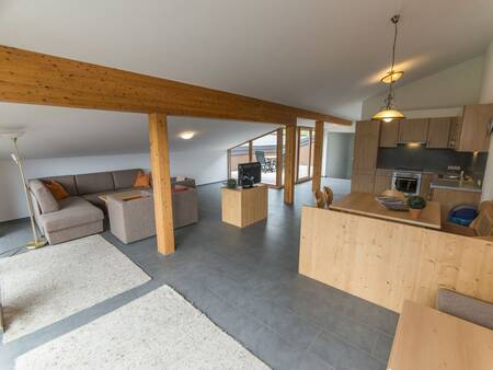 Living room with kitchen of an apartment at Landal Alpen Chalet Matin