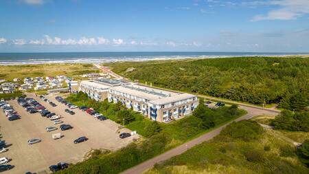 Aerial view of Landal Ameland State with dunes and the sea