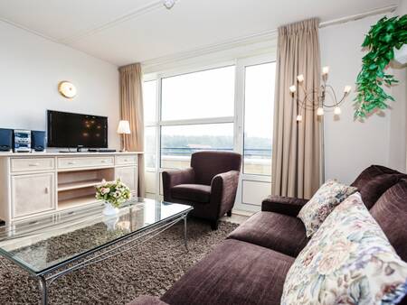 Living room with large windows of an apartment on Landal Ameland State