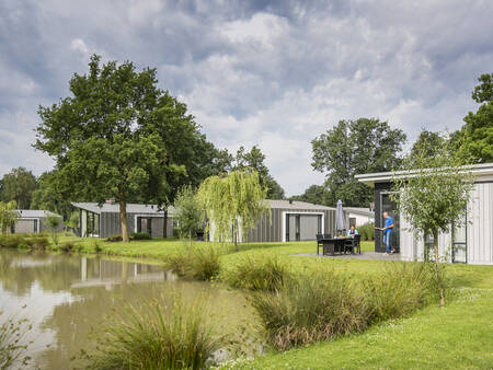 Holiday homes along a water at the Landal Amerongse Berg holiday park