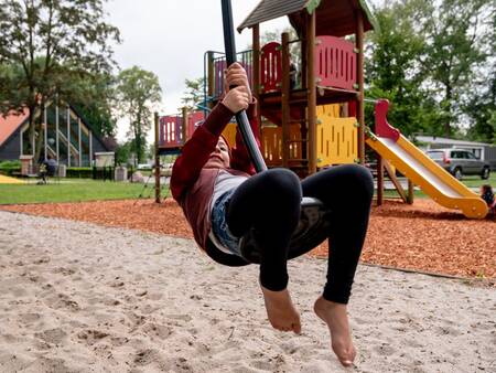 Child plays in the playground at Landal Amerongse Berg holiday park