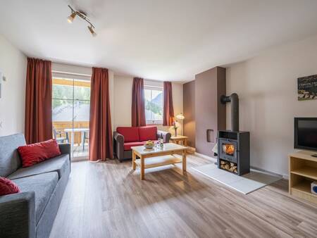 Living room with wood stove of an apartment at the Landal Bad Kleinkirchheim holiday park