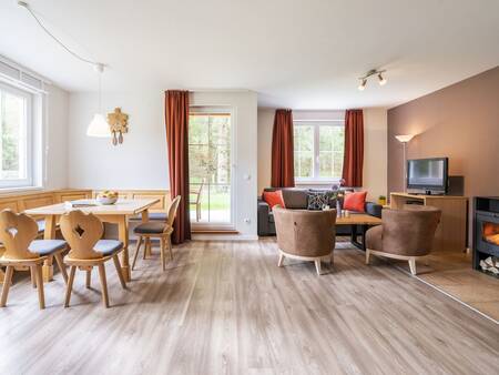 Living room with dining table of an apartment at Landal Bad Kleinkirchheim