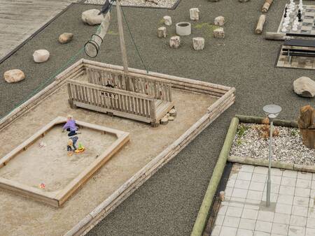 Child plays in a sandbox in the playground at Landal Beach Park Ebeltoft