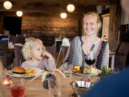 A family dines in the restaurant at the Landal Beach Park Ebeltoft holiday park