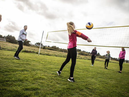 People play volleyball on the volleyball court of holiday park Landal Beach Park Grønhøj Strand