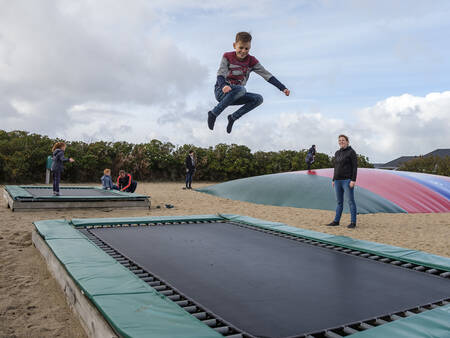 Children jump on trampolines in the playground at Landal Beach Park Grønhøj Strand