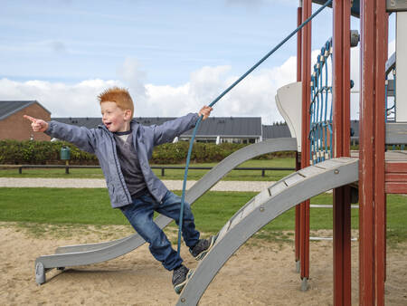 Child plays in the playground at holiday park Landal Beach Park Grønhøj Strand