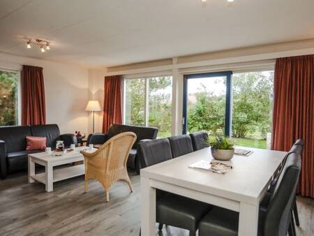 Living room with dining area of a holiday home at Landal Beach Park Texel holiday park