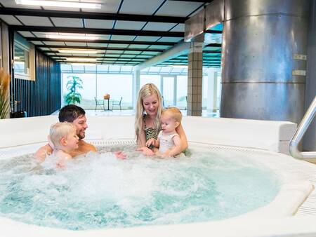 Family in the hot tub of the pool at Landal Strandappartementen Fyrklit