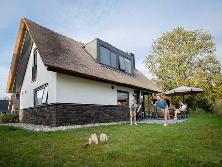 Children play in the garden of a holiday home at the Landal Berger Duinen holiday park