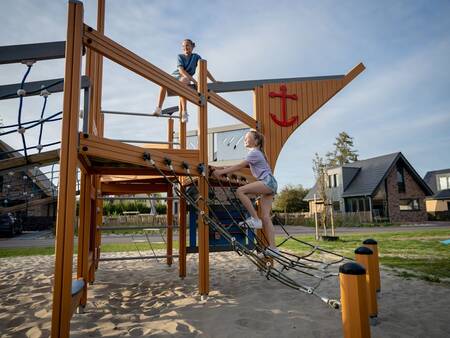 Children climb on a playground equipment in a playground at the Landal Berger Duinen holiday park