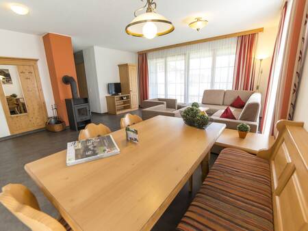 Living room with stove of an apartment at Landal Brandnertal