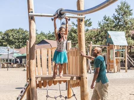 A family plays in the playground at the Landal Coldenhove holiday park