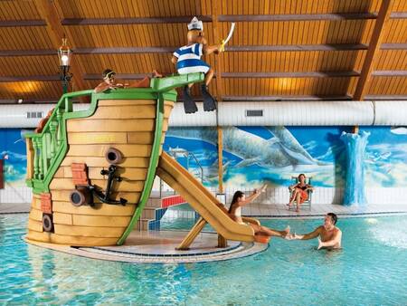 A child slides down the slide in the indoor pool of holiday park Landal Coldenhove
