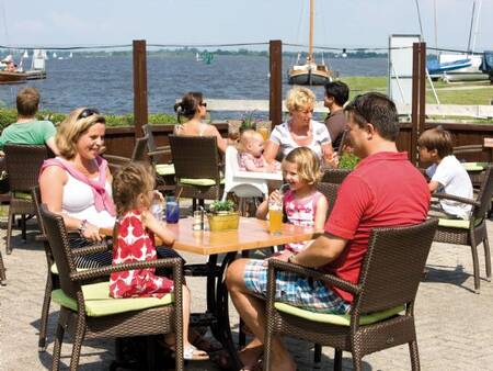 A family enjoys a drink at Pavilion De Bloemert at the Landal De Bloemert holiday park