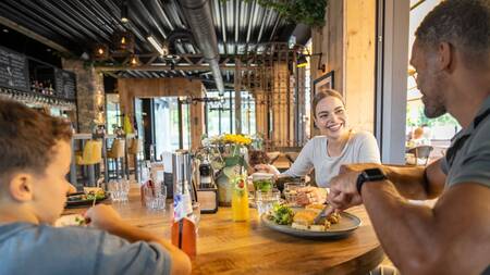 Family having dinner in the restaurant of Landal De Strabrechtse Vennen