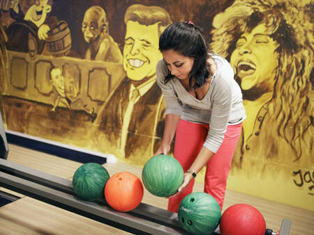 A woman at the bowling alley of holiday park Landal De Vers