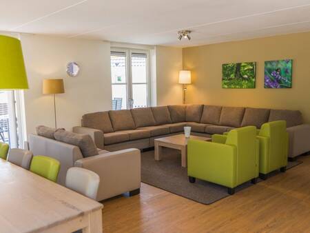 Living room with large sofa in a holiday home at Landal De Vers . holiday park