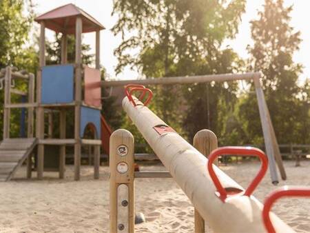 Climbing device and seesaw in a playground at Landal De Vlegge holiday park