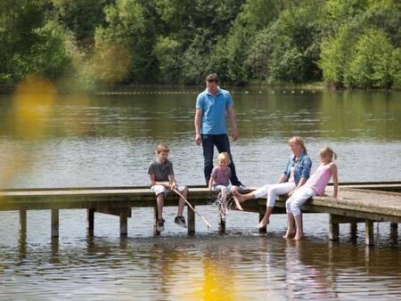 Fishing from a jetty in the recreational lake at Landal De Vlegge holiday park