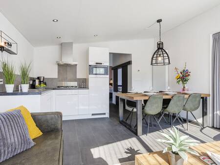 Kitchen with dining area of a holiday home at Landal De Vlinderhoeve holiday park