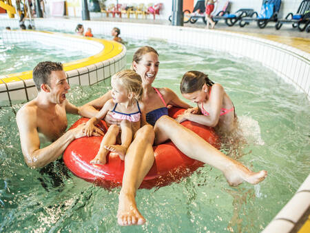 Family floats in the rapids of the swimming pool of Landal Domein de Schatberg