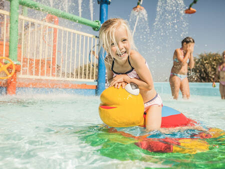 Children play in the outdoor pool of the Landal Domein de Schatberg holiday park