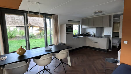 Dining table and kitchen of a holiday home at the Landal Drentse Lagune holiday park