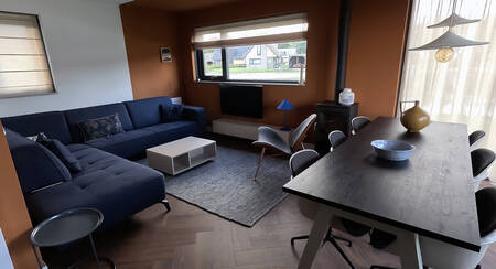 Living room with dining area in a holiday home at the Landal Drentse Lagune holiday park