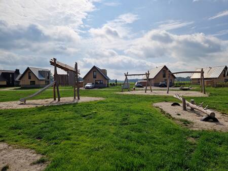 Large playground at the Landal Drentse Lagune holiday park with swing, seesaw and slide