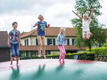 Children jump on the air trampoline in a playground at the Landal Duc de Brabant holiday park