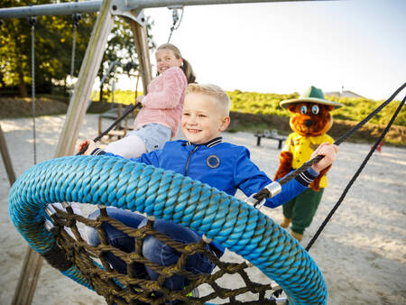 Swing in a playground at holiday park Landal Dwergter Sand