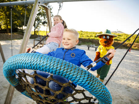 Swing in a playground at holiday park Landal Dwergter Sand