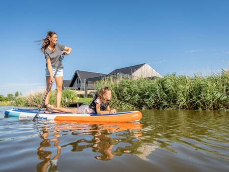 Mother and daughter paddle on a canal at Landal Elfstedenhart holiday park
