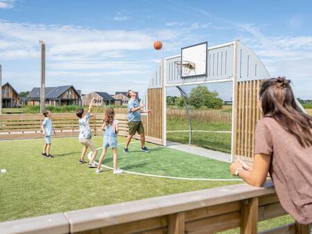 Children play on the multifunctional sports field at the Landal Elfstedenhart holiday park