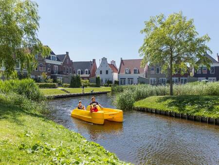 Family on a pedal boat on a canal of the Landal Esonstad holiday park