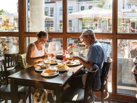 Couple dines in a restaurant at Landal Esonstad holiday park