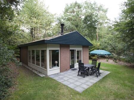 Garden with terrace of a holiday home at Landal Heideheuvel holiday park