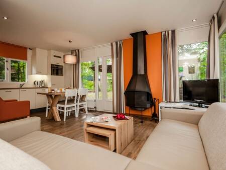Living room, kitchen and dining area of a holiday home at Landal Heideheuvel holiday park