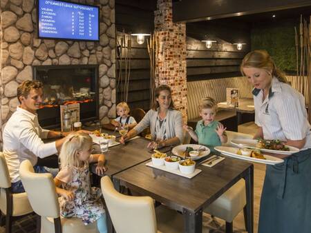 Family dines in restaurant Het Land van Bartje at holiday park Landal Het Land van Bartje