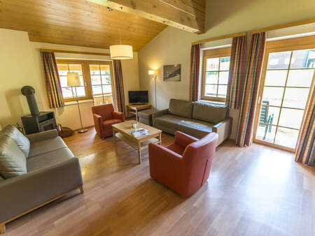 Living room with wood stove of an apartment at Landal Hochmontafon
