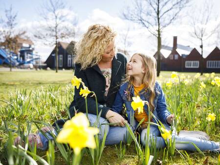 Mother and daughter on a lawn at the Landal Hof van Saksen holiday park