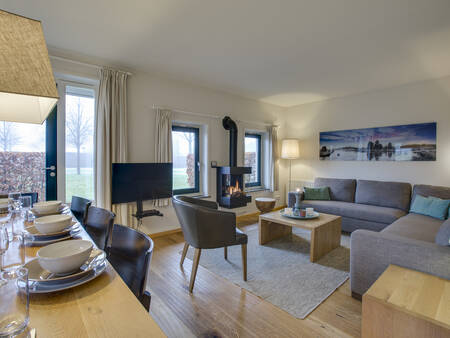 Living room and dining area of a holiday home at the Landal Hof van Saksen holiday park