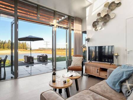 Living room with large windows at Landal Holiday Park Sallandse Heuvelrug