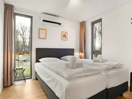 Bedroom with a luxury double bed at Landal Holiday Park Sallandse Heuvelrug