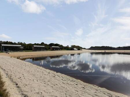 Recreational lake with sandy beach at Landal Holiday Park Sallandse Heuvelrug