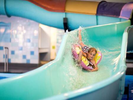 Girl on the slide in the swimming pool of Landal Holiday Park Sallandse Heuvelrug