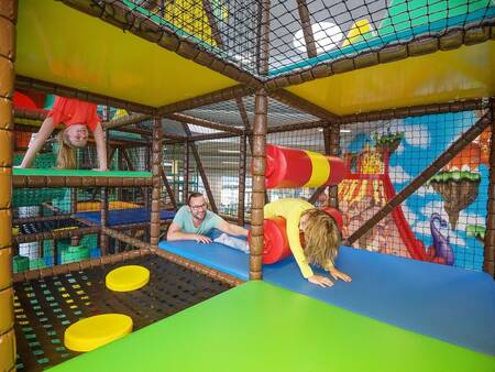 Children play in the indoor playground of Landal Holiday park Rønbjerg